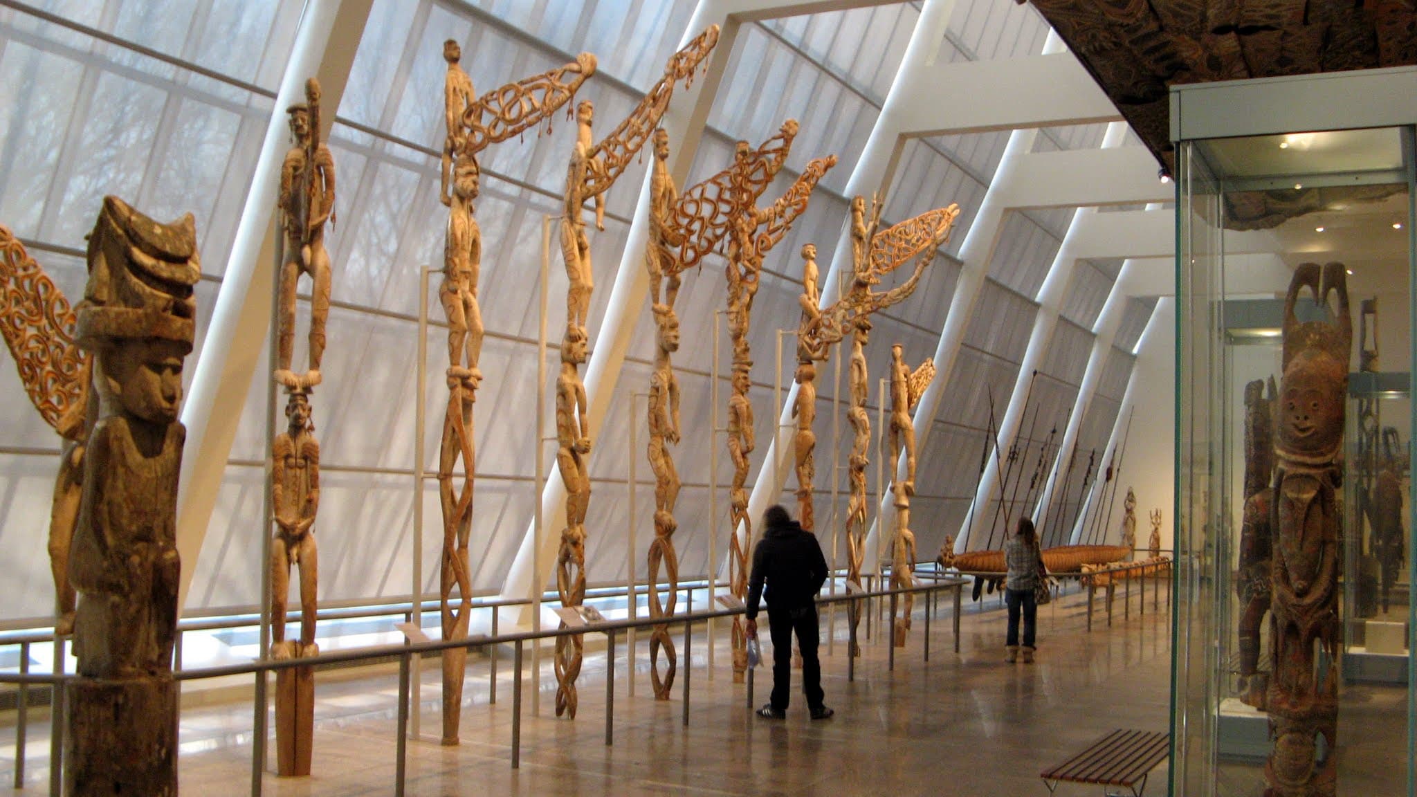 Carved Asmat bisj ancestor poles standing against the sky in New Guinea