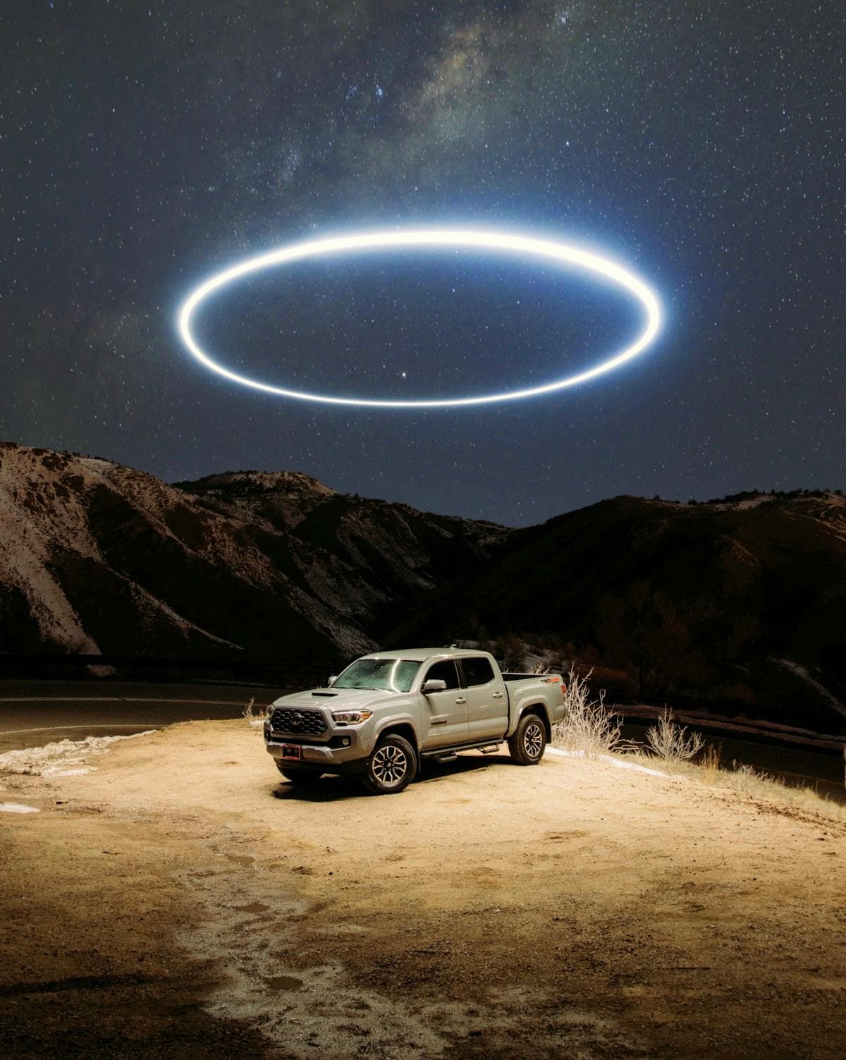 Mysterious circular light formation in the night sky above a remote area, similar to the unexplained lights reported at Skinwalker Ranch