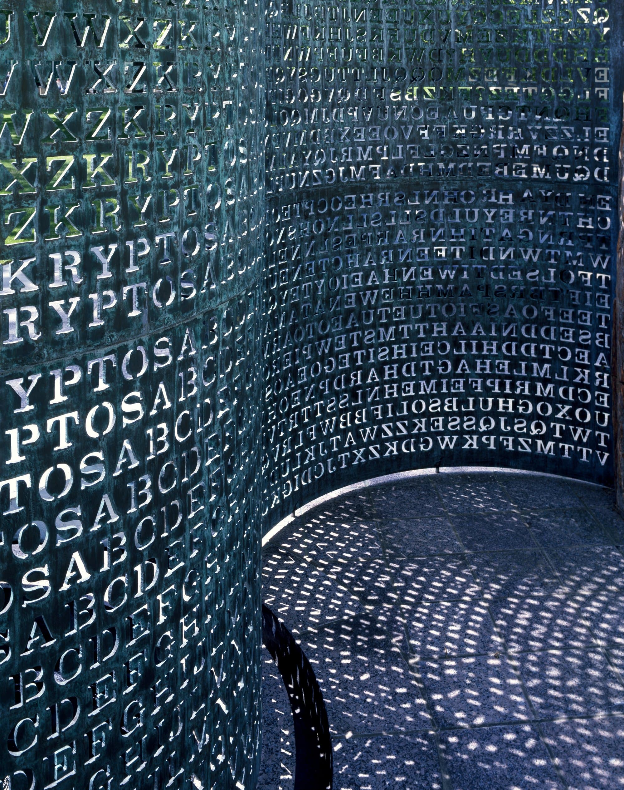 The Kryptos sculpture, an S-shaped copper screen of punched letters, on the grounds of CIA headquarters in Langley, Virginia.