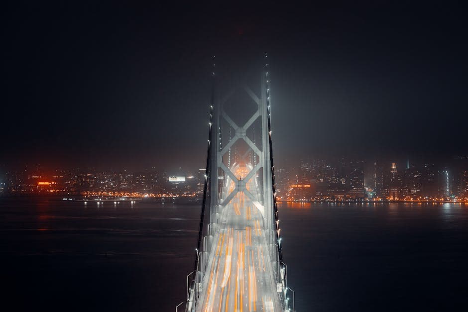 Suspension bridge illuminated at night, evoking the Silver Bridge that connected Point Pleasant to Gallipolis, Ohio