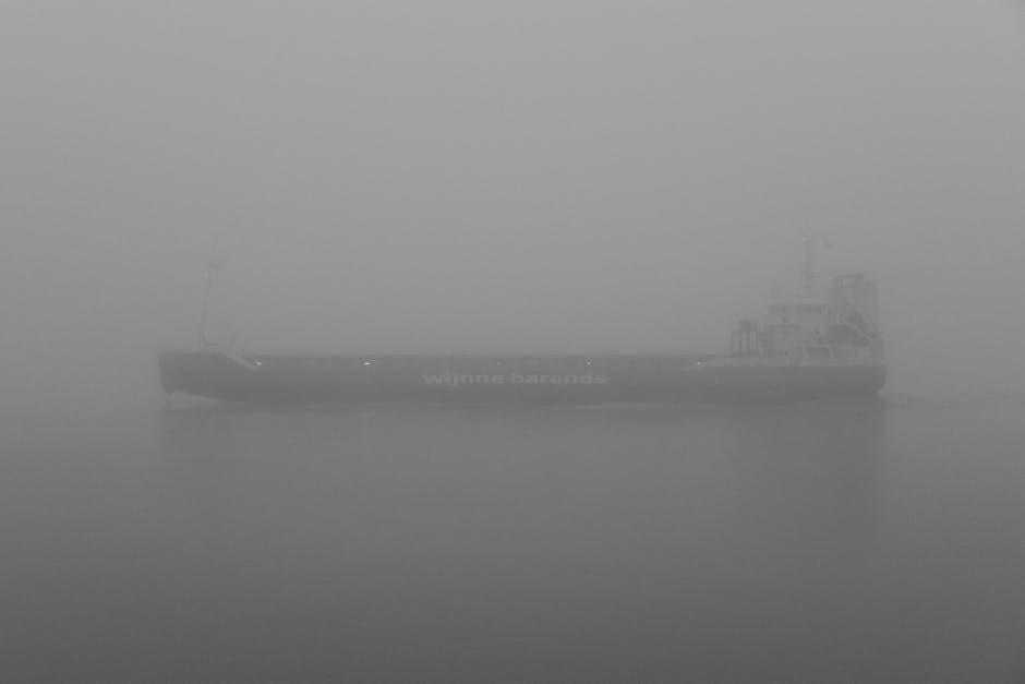 A cargo ship sailing through dense fog on calm waters, similar to the conditions ships would have faced in the Bermuda Triangle